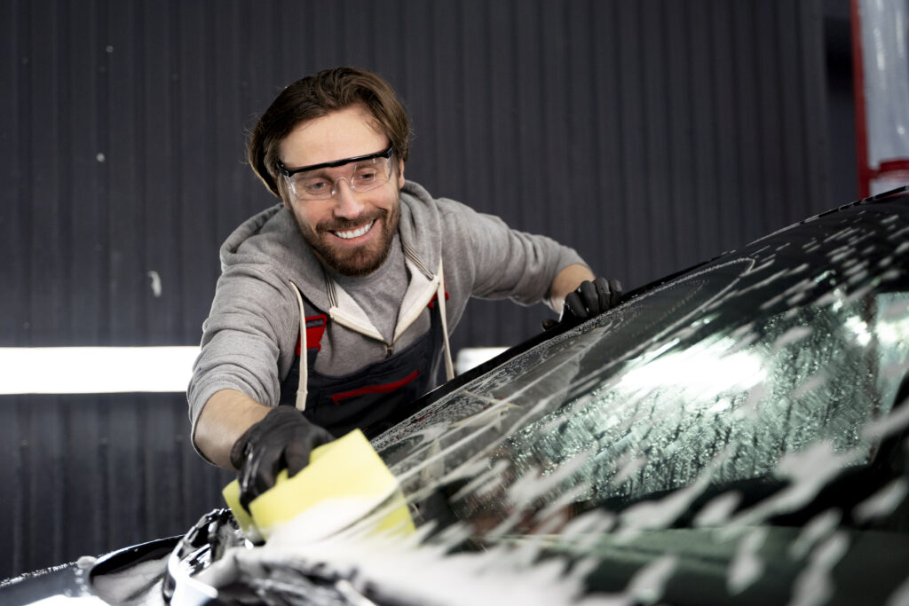a person cleaning windshield after replacing