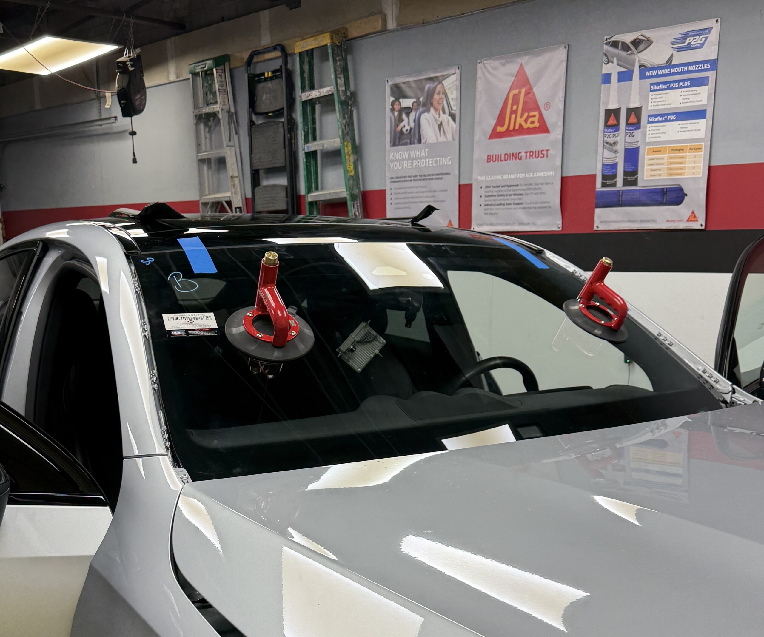Windshield installation with suction cup handles at Save On Auto Glass