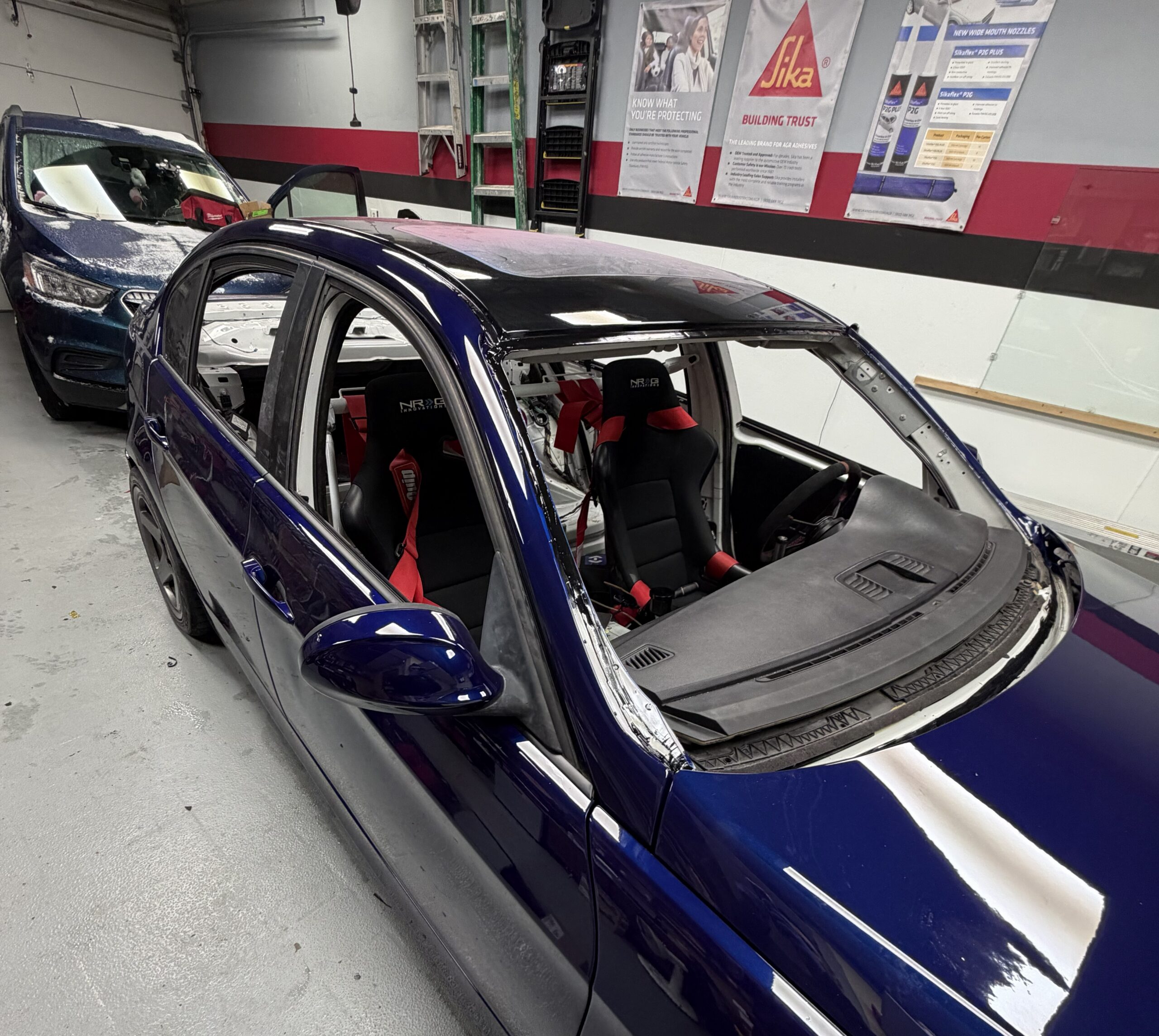 Car with windshield removed before replacement