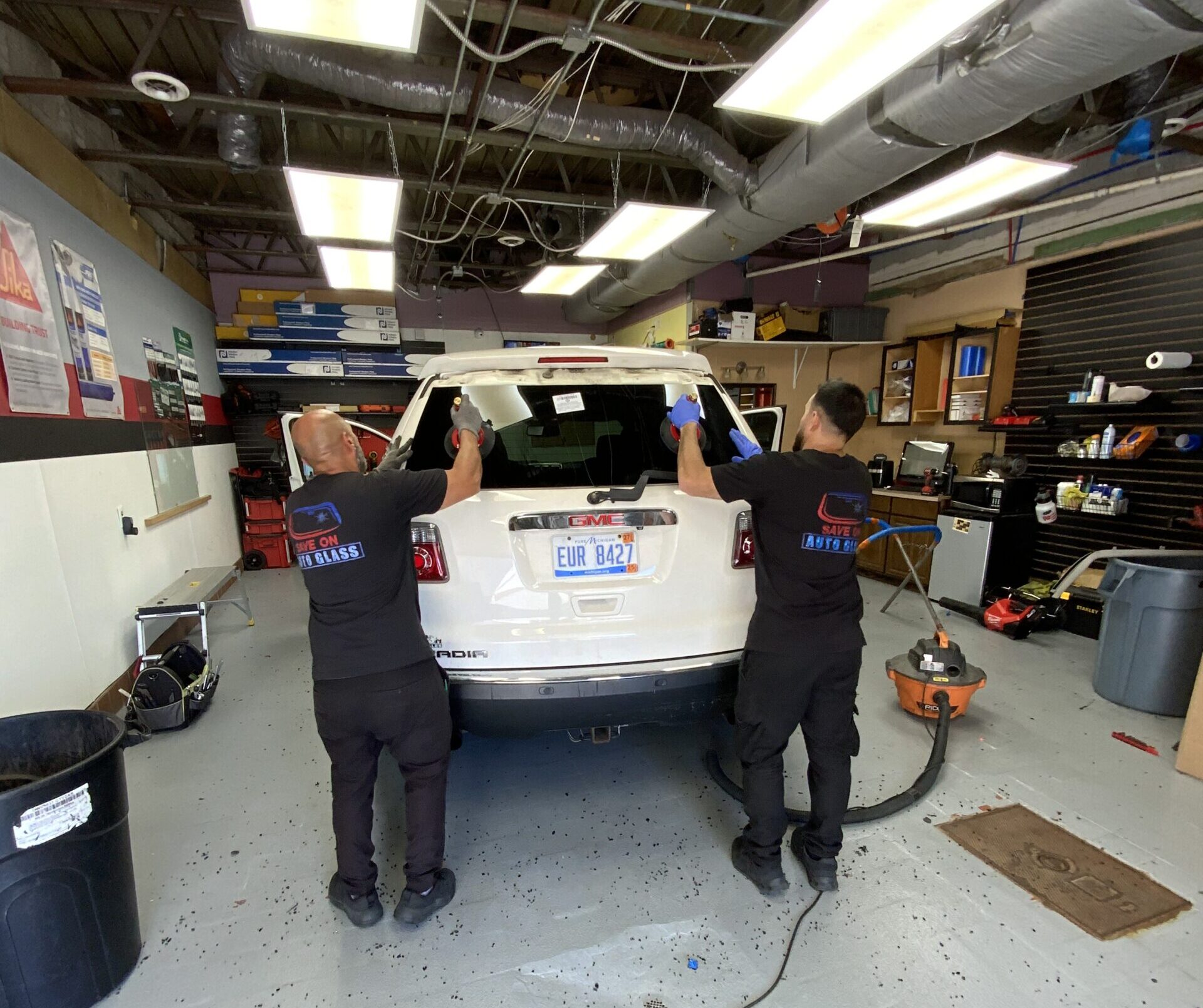 save on auto glass technicians are replacing rear windshield