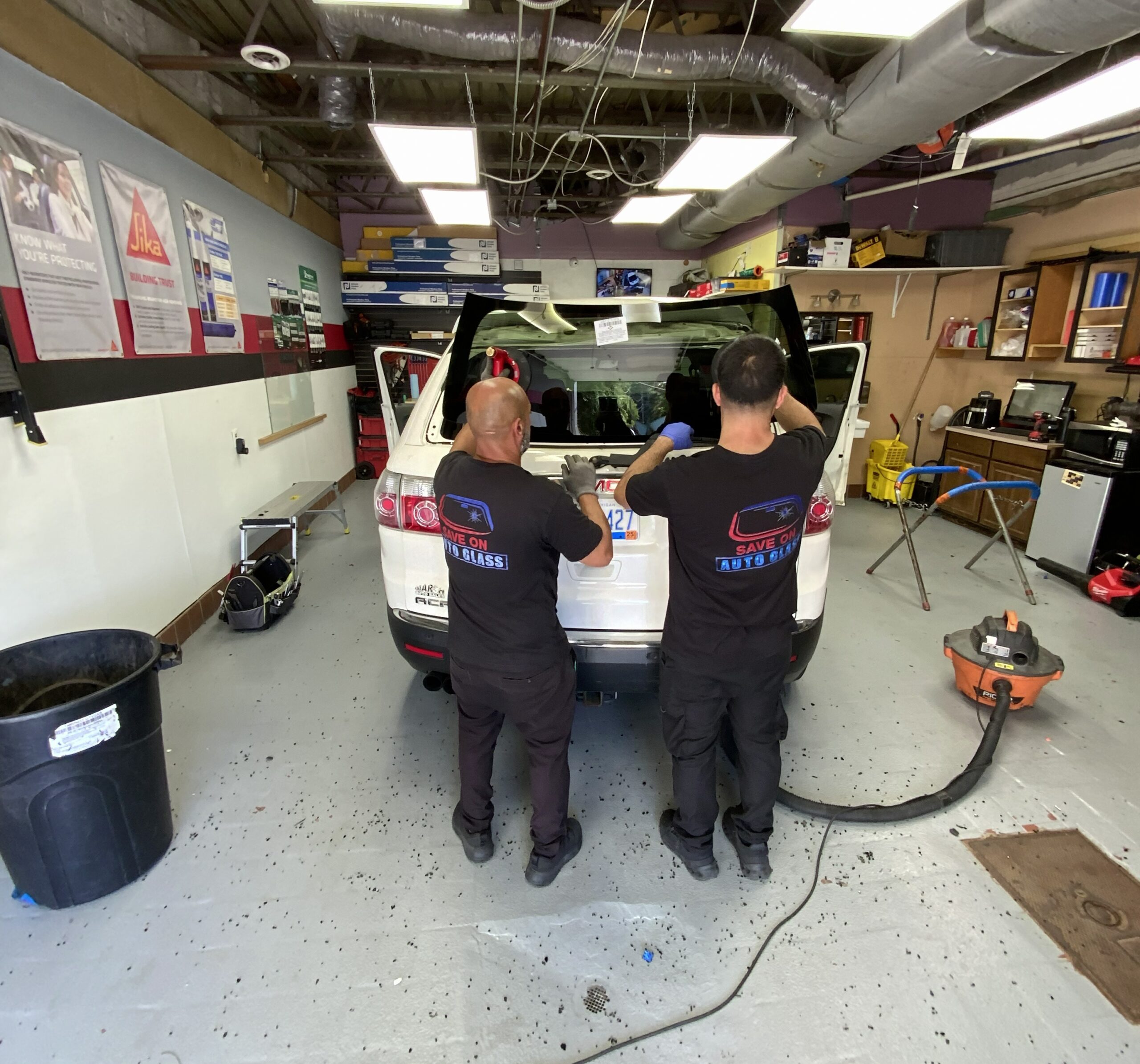 save on auto glass technicians are replacing back glass