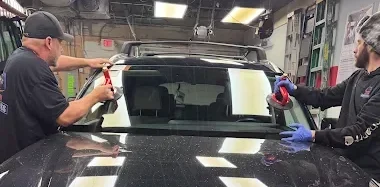 save on auto glass technicians are replacing the windshield