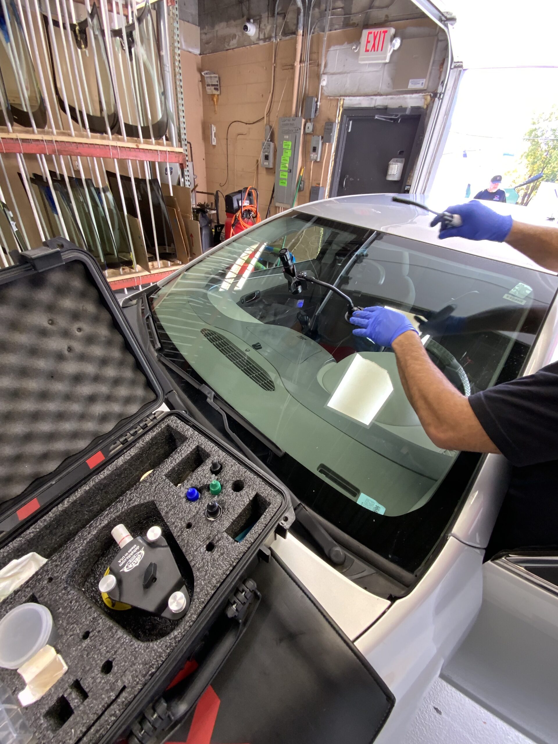 Save on auto glass technician repairing a windshield