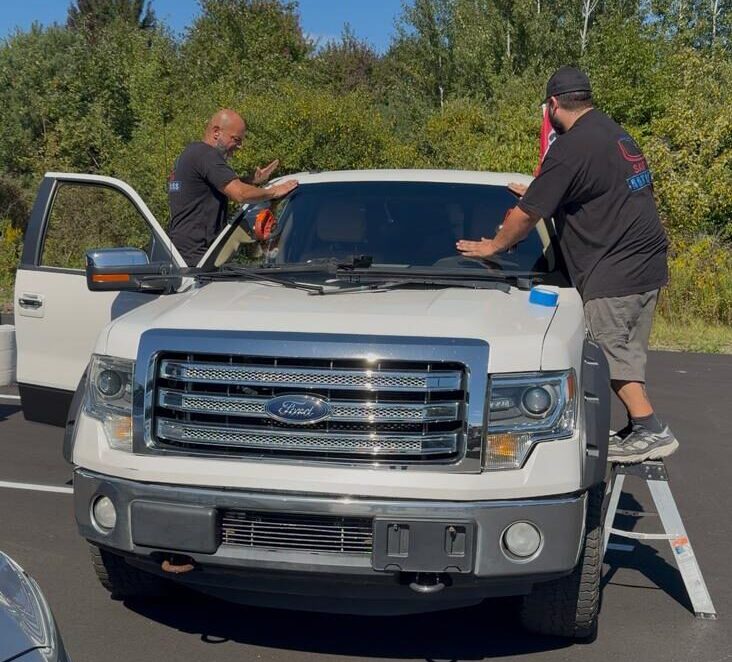 save on auto glass technician replacing a windshield