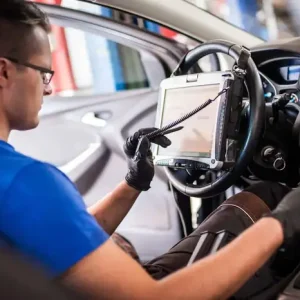 Expert Safety Systems Recalibration: Ensuring Vehicle Reliability and Performance A technician performing a safety systems recalibration on a vehicle using advanced diagnostic equipment.